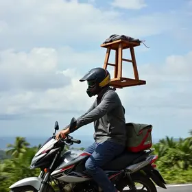 motociclista é flagrado transportando ‘banquinhos’ na cabeça